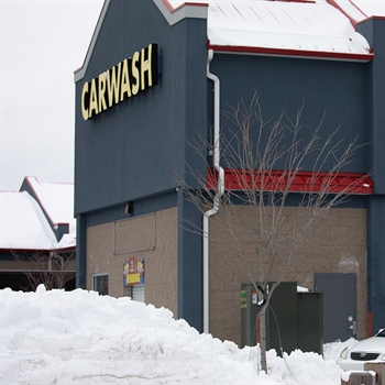 Color Snap® snow guards for metal roofing installed on car wash.