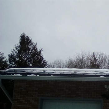 Snow-covered roof showcasing AceClamp system's effectiveness in Stonington.