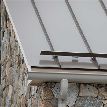 Color Snap snow rails installed on metal roofing with snap-in ice clips