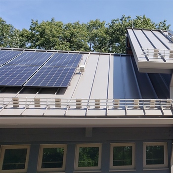 AceClamp solar panel snow guards installed on a metal roof